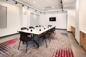 a conference room with a table and chairs at Aloft Lawrenceville Sugarloaf in Lawrenceville