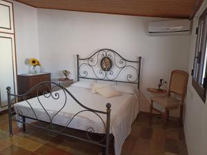 サン・ヴィートにあるAppartamento Ginepro Sardegnaのベッドルーム1室(ベッド1台、椅子付)