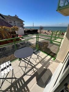 a patio with chairs and a view of the beach at Au Petit Wissant in Wissant