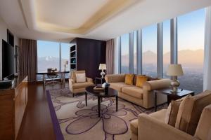 a living room with a couch and a table at The Ritz-Carlton, Almaty in Almaty