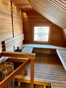 a sauna with a table and a window in it at Otavalan ullakko in Tampere