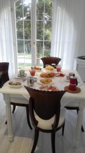 a white table with food on top of it at Caterina.C B&B in Val Della Torre