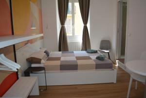 um pequeno quarto com uma cama e uma janela em Orti House Apartments - total renovation on Apr 2023 em Milão