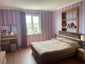 a bedroom with a large bed and a window at wine valley in Udabno