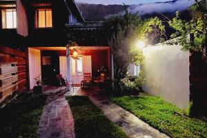 a backyard at night with a house with a patio at Le Margousier in Cilaos
