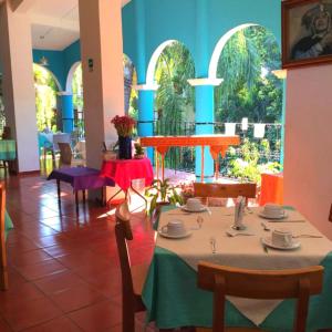 a dining room with a table and chairs in a building at Hotel La Ceiba in Chiapa de Corzo