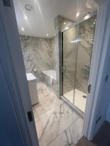 a bathroom with a shower and a sink at Stunning Marylebone apartment in London
