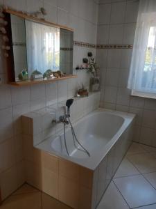 a bath tub with a faucet in a bathroom at Wohlfühloase in Suhl