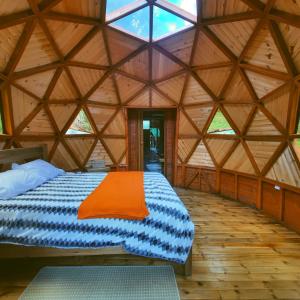 a large room with a bed in a yurt at FINCA CELESTIAL in Pacho