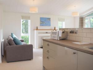 a kitchen with a counter and a couch in a room at Lodge 5 in Kinlet