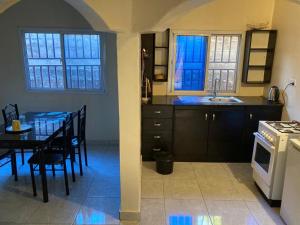 a kitchen and dining room with a table and a stove at Star Lodge 