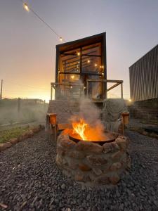 a fire pit with a building in the background at Cabana Cambará in Cambará