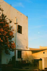 a building with a table and chairs in front of it at Hippie Chic - Room L'oued in Essaouira +4 photos