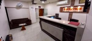 a barber shop with a red purse on the counter at Hotel Orange in Vapi