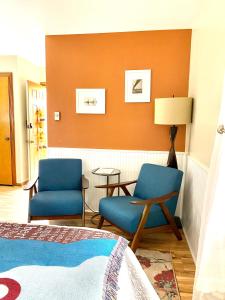 a hotel room with two chairs and a bed at Remington Flats in Fort Collins