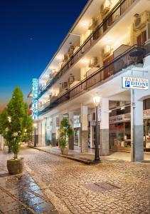 an empty street in front of a building at night at Dioni Hotel in Ioannina