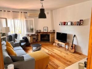 a living room with a couch and a fireplace at Catalunya Casas Blissful Costa Dorada Escape with private pool in Bisbal del Penedès