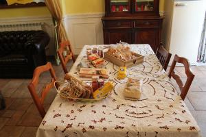 a dining room table with a table cloth with food on it at Bed And Breakfast SOPRANOS in La Spezia