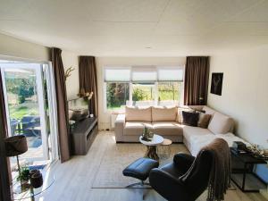 a living room with a couch and a table at Sandy Feet Retreat in Petten