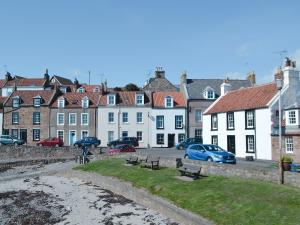 a group of buildings and cars parked on a street at Nautilus Cottage in Cellardyke