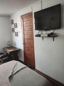 a bedroom with a flat screen tv on a wall at Porta 301 con la mejor ubicación en Miraflores. in Lima