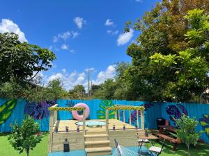 マイアミにあるArt Graffitiの青柵のある公園内の遊び場