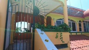 une maison avec une porte et un escalier en face de celle-ci dans l'établissement El Tucan, à Puerto Escondido