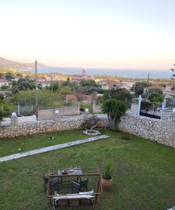 a garden with a view of the ocean at Lofos house in Karavadhos