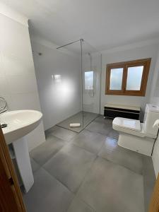 a bathroom with a shower and a toilet and a sink at Villa Son Serra de Marina in Son Serra de Marina