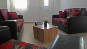 a living room with two couches and a coffee table at Cozy ground floor house in Agia Triada
