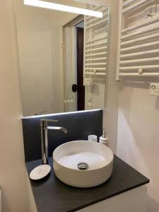 a bathroom with a white sink and a mirror at Appartement 1 chambre moderne à proximité du circuit des 24h in Le Mans