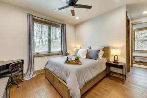 a bedroom with a bed and a ceiling fan at Cottage with Screened Porch and Trails Near Cashiers! in Glenville