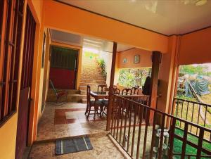 a room with a balcony with a table and chairs at Ceiba lodge in Drake