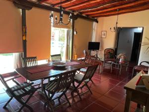 a dining room with a wooden table and chairs at Alquilo casa quinta in Pocito