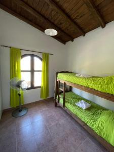 a room with two bunk beds and a window at Cabaña Club Nautico Los Reyunos in San Rafael
