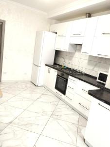 uma cozinha branca com armários e electrodomésticos brancos em НОВОБУДОВА,СТРИЙСЬКА,Автовокзал ,СИХІВ ARENA Карла Мікльоша em Lviv