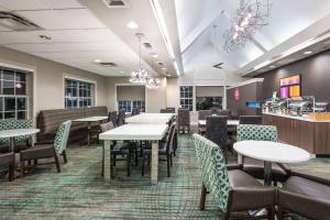 a dining room with tables and chairs at Residence Inn Brownsville in Brownsville