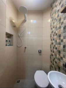 a bathroom with a shower and a toilet and a sink at Suíte privada no melhor do Leblon in Rio de Janeiro