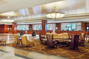 a lobby with tables and chairs in a building at Sheraton Boston Hotel in Boston