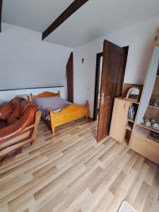 a bedroom with a bed and a wooden floor at Nocleg U Jagódki in Zubrzyca Dolna