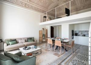 a living room with a table and a couch at Villa Bertoni Terrazzo - Tremezzo by LoveComo in Tremezzo