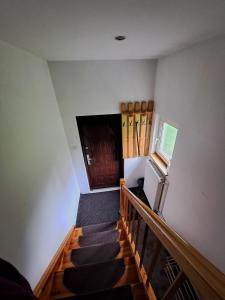 a room with stairs with a television and a door at Nocleg U Jagódki in Zubrzyca Dolna
