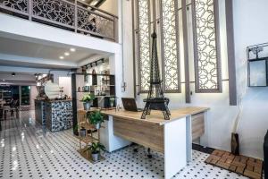 a lobby with a desk with a eiffel tower on it at Sclass Townhome, 5 min from Night Market old city in Chiang Mai