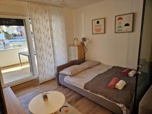 a small bedroom with a bed and a table at Alena Home - Prestige and new apartment in Premantura