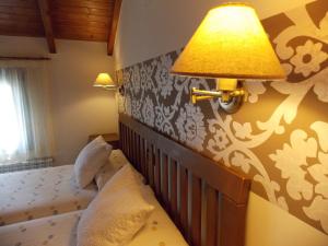 Postel nebo postele na pokoji v ubytování Hostal El Recanto