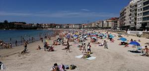 a large group of people on a beach at Apartamento BELA VISTA in Sanxenxo