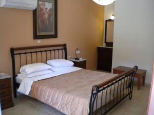 a bedroom with a large bed and a mirror at IRIDA VILLA in Ayia Evfimia
