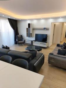 a living room with couches and a flat screen tv at Bursa Dream Apartment in Bursa