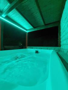 a swimming pool with blue lights in a room at Residence Del Tellaro in Noto Marina