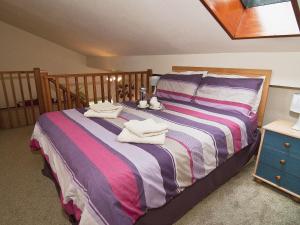 a bedroom with a bed with towels on it at St Andrews Barn in Necton